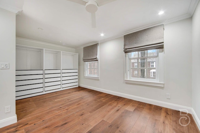 interior space with hardwood / wood-style flooring, ornamental molding, and ceiling fan