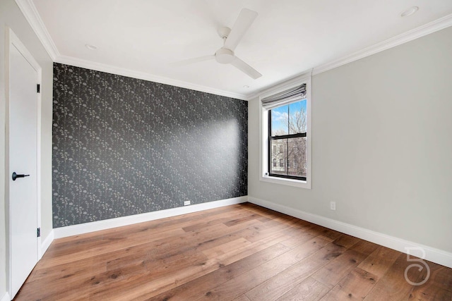 unfurnished room with crown molding, hardwood / wood-style floors, and ceiling fan