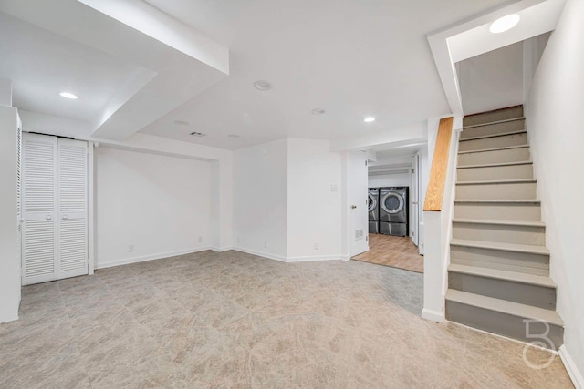 interior space featuring separate washer and dryer and light colored carpet