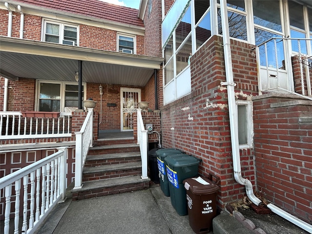 view of exterior entry featuring covered porch