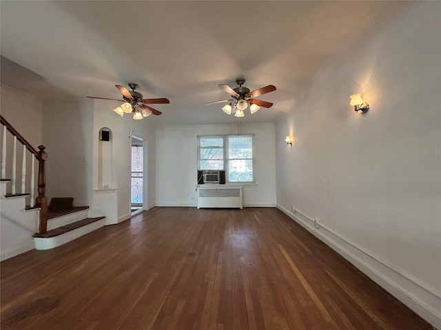 unfurnished living room with ceiling fan, radiator, cooling unit, and dark hardwood / wood-style floors