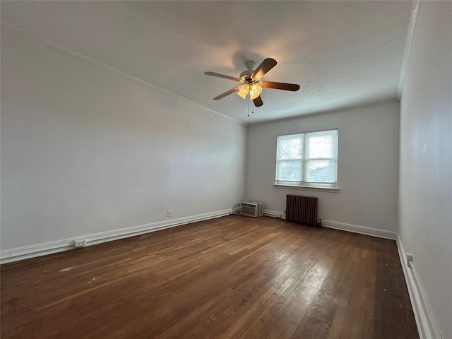 spare room with radiator, dark wood-type flooring, ornamental molding, and ceiling fan