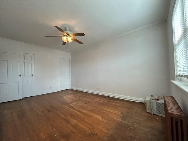 unfurnished bedroom with dark hardwood / wood-style flooring, radiator heating unit, ornamental molding, and ceiling fan