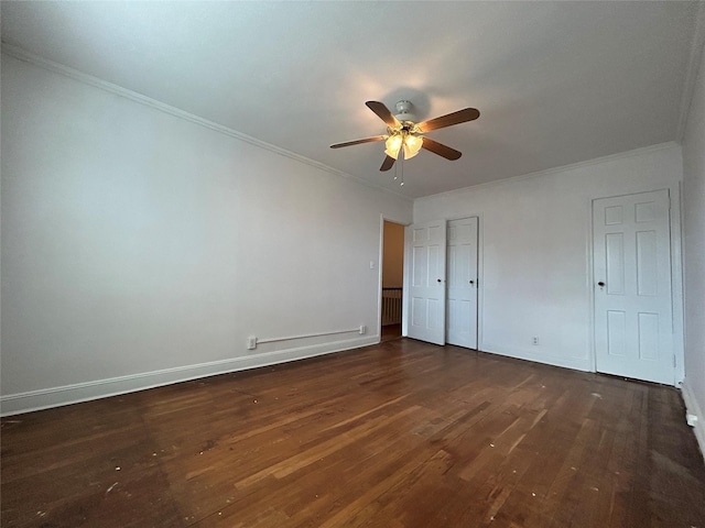 unfurnished bedroom featuring ornamental molding, dark hardwood / wood-style floors, and ceiling fan