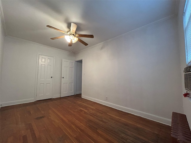 unfurnished bedroom featuring dark hardwood / wood-style flooring, ornamental molding, and ceiling fan