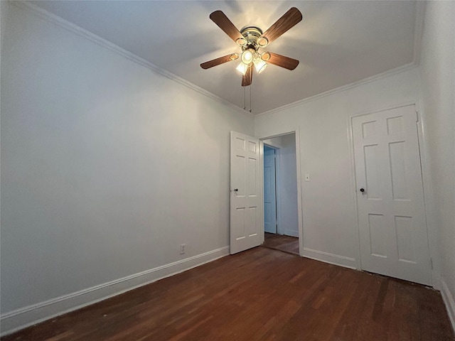 unfurnished bedroom with dark wood-type flooring, ornamental molding, and ceiling fan