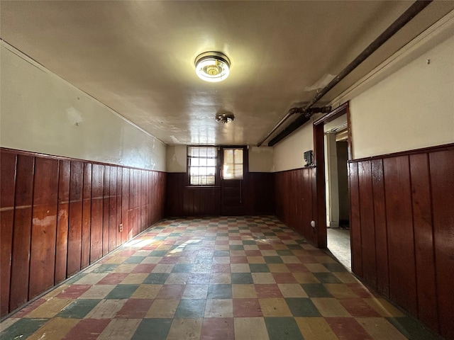 additional living space featuring wood walls