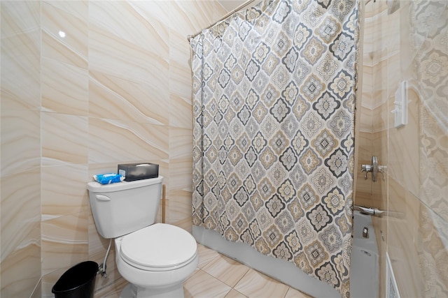 bathroom featuring walk in shower, tile walls, and toilet