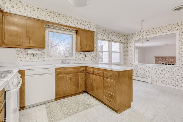 kitchen featuring an inviting chandelier, hanging light fixtures, baseboard heating, kitchen peninsula, and white appliances