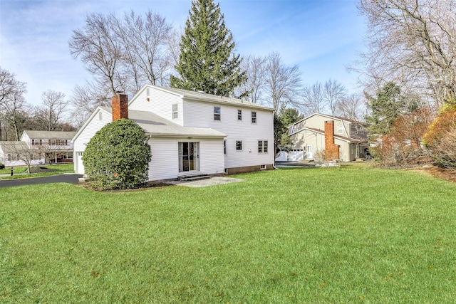 rear view of property featuring a yard