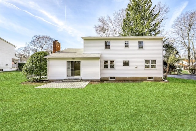 rear view of property with a yard and a patio area