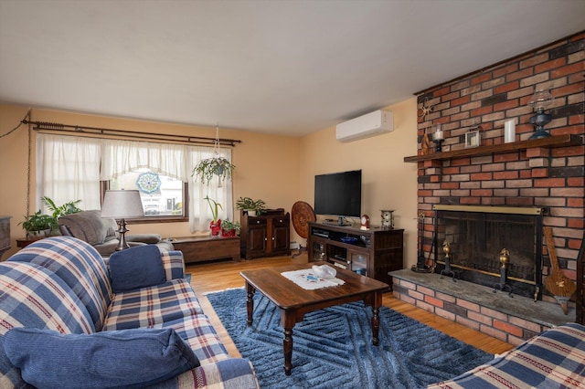 living room with hardwood / wood-style floors, a fireplace, and an AC wall unit