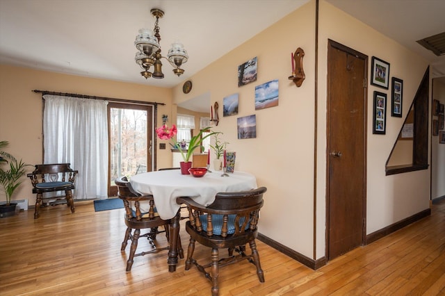 dining room featuring a notable chandelier and light hardwood / wood-style floors