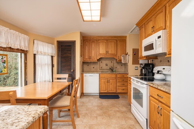 kitchen featuring sink, white appliances, and decorative backsplash