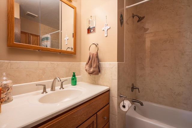 bathroom with vanity, shower / bathtub combination with curtain, and tile walls