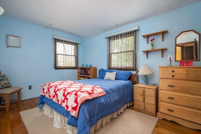 bedroom with dark hardwood / wood-style flooring and vaulted ceiling