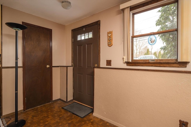 entrance foyer featuring dark parquet floors