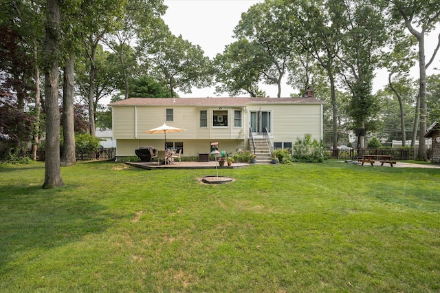 back of property featuring a yard and a fire pit