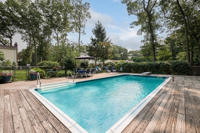 view of swimming pool featuring a wooden deck