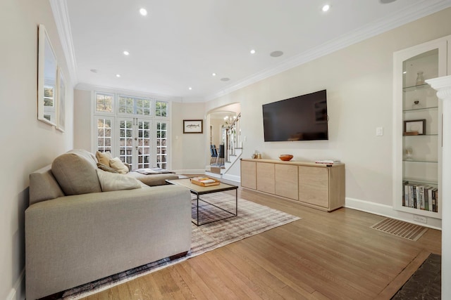 living room featuring ornamental molding and wood-type flooring