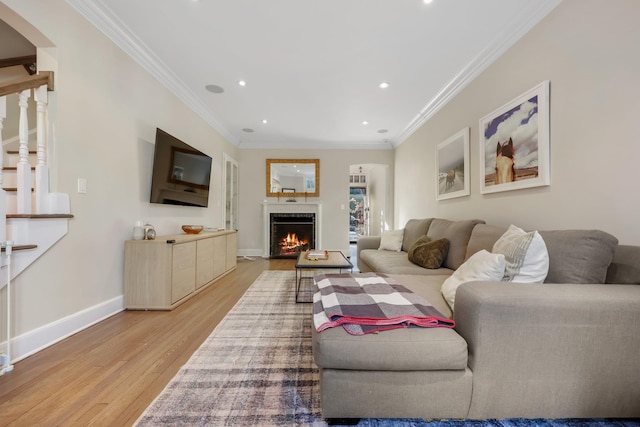 living room with hardwood / wood-style flooring and ornamental molding