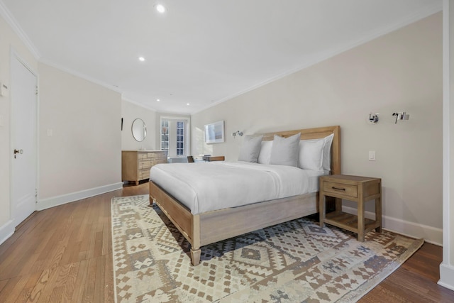 bedroom featuring ornamental molding and light hardwood / wood-style floors