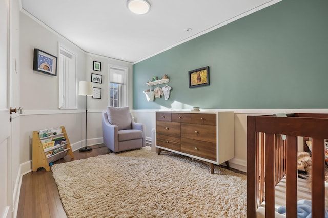 bedroom with hardwood / wood-style floors and crown molding