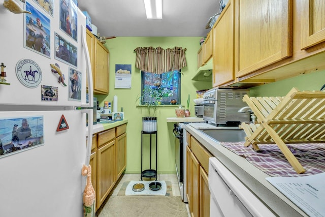 kitchen featuring stove, sink, dishwasher, and white refrigerator