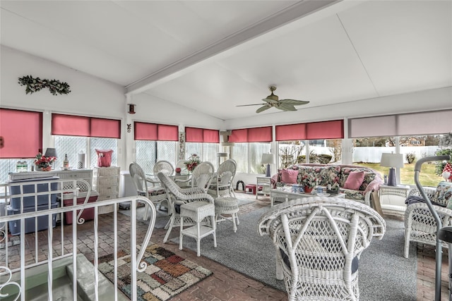 sunroom featuring lofted ceiling with beams and ceiling fan