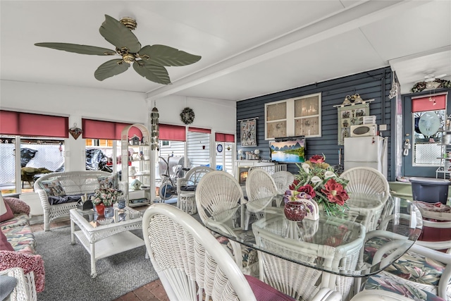 dining space featuring beam ceiling and ceiling fan