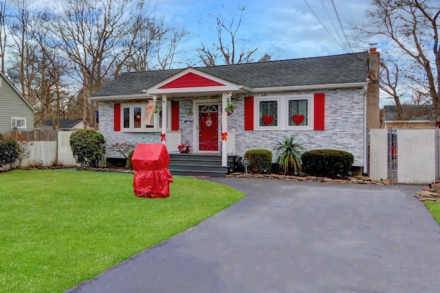 bungalow-style home featuring a front yard