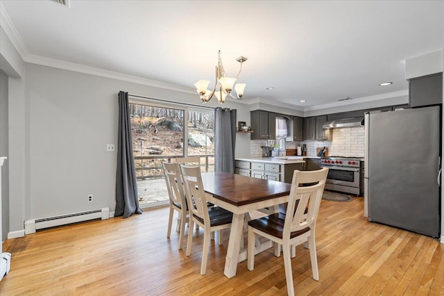 dining space featuring light wood-style flooring, recessed lighting, a baseboard heating unit, an inviting chandelier, and crown molding