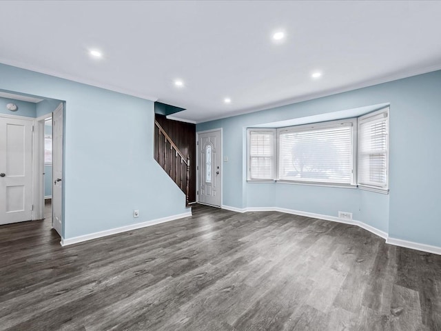 unfurnished living room with ornamental molding and dark hardwood / wood-style flooring