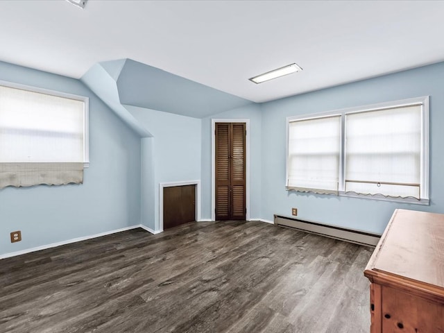 bonus room with lofted ceiling, a baseboard heating unit, and dark wood-type flooring