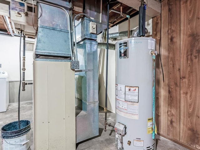 utility room with heating unit and water heater