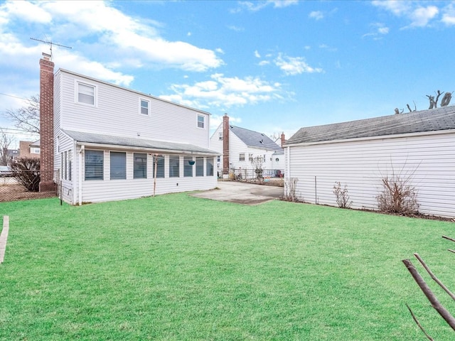 back of house featuring a yard and a patio area