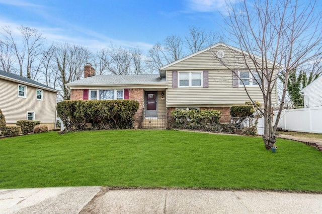 tri-level home with a front yard