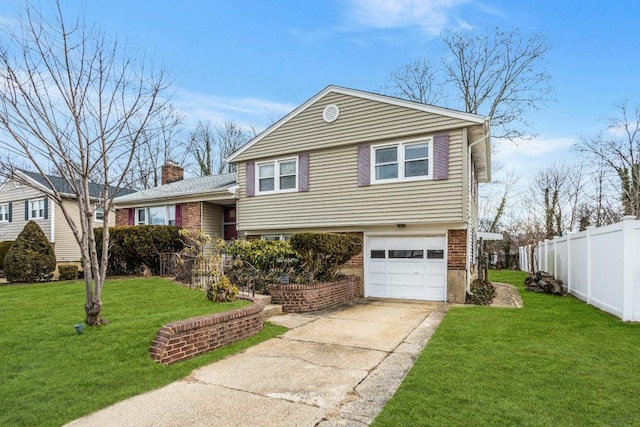 tri-level home with a garage and a front lawn