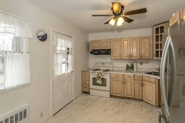 kitchen featuring sink, stainless steel refrigerator, radiator heating unit, range hood, and white range with electric stovetop