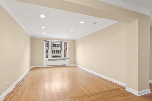 unfurnished living room with hardwood / wood-style flooring, crown molding, and radiator