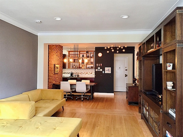 living room with wood-type flooring and crown molding