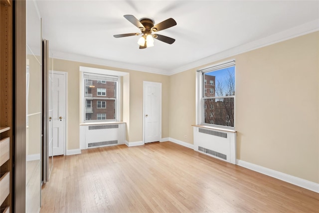 unfurnished living room with a healthy amount of sunlight, radiator heating unit, and light hardwood / wood-style flooring