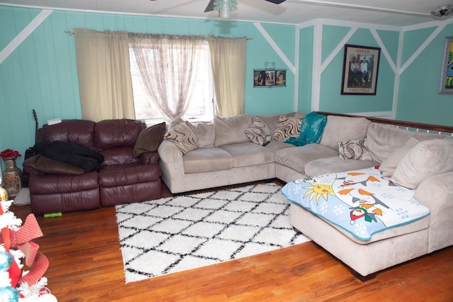 living room with wood-type flooring and ceiling fan