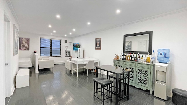 dining room with crown molding, indoor bar, dark hardwood / wood-style flooring, and a baseboard heating unit