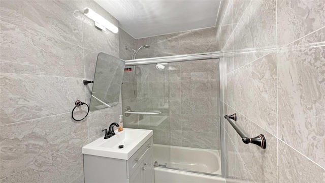 bathroom with vanity and enclosed tub / shower combo