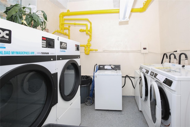 laundry area with stacked washer and clothes dryer and washer and dryer