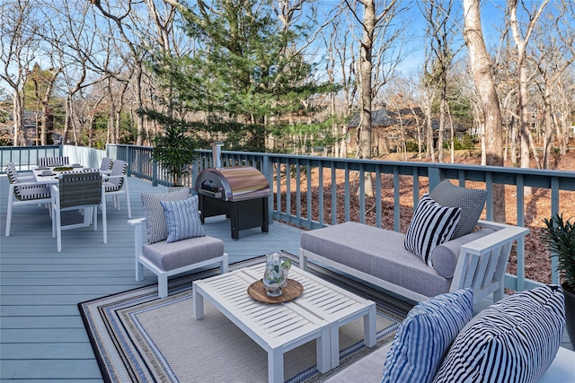 wooden terrace with area for grilling and outdoor lounge area