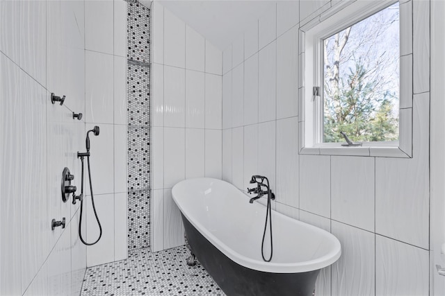 bathroom featuring a bath and tile walls