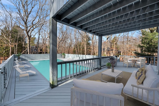 wooden deck with a fenced in pool