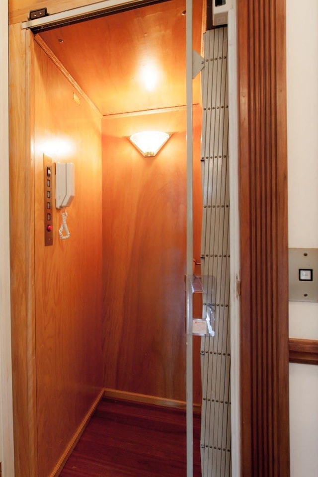 interior details with elevator and wood-type flooring